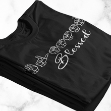 Load image into Gallery viewer, Blessed (American Sign Language) T-Shirt: A black t-shirt with white wording that says &quot;Blessed&quot; in American Sign Language, fingerspelling. Below it, it has &quot;Blessed&quot; in English. 
