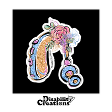 Load image into Gallery viewer, The Hearing Aid with Flowers on a black background sticker. The Disability Creations logo is on the bottom. 
