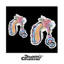 Load image into Gallery viewer, Two Colorful Glittery Hearing Aid with Flowers stickers on a black background.