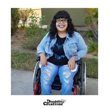 Load image into Gallery viewer, A photo of Nelly wearing a jean jacket over the Disability Community Love T-Shirt
