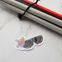 Load image into Gallery viewer, A Eyeglasses Sticker next to a white cane.