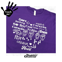 Load image into Gallery viewer, A purple shirt with white design. On the top left is a black hand. On the palm, it says, "Touch me." The Disability Creations logo is at the bottom.