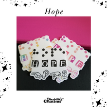Load image into Gallery viewer, Three options of Hope stickers. The black option is in the center front. Two stickers in the back: the rainbow on the left and the pink-peach ombre. on the right. 