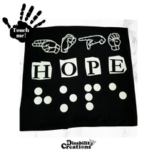 Load image into Gallery viewer, A black t-shirt says &quot;Hope&quot; in three different languages in white vinyl. The first line is &quot;Hope&quot; in Braille. The second line has &quot;Hope&quot; in English, and the third line has Hope in American Sign Language- fingerspelling. Raised vinyl used to be able to read love in Braille.
