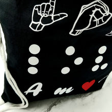 Load image into Gallery viewer, The drawstring bag standing on a table.