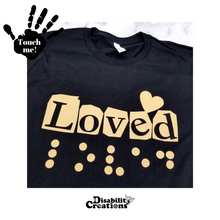 Load image into Gallery viewer, A folded black shirt with the carnel design. On the top left is a black hand. On the palm, it says, "Touch me." The Disability Creations logo is at the bottom.