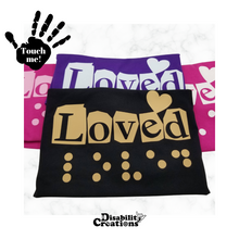 Load image into Gallery viewer, Four folded shirts. On the top left is a black hand. On the palm, it says, "Touch me." The Disability Creations logo is at the bottom.