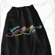 Load image into Gallery viewer, A Black tote bag outline of three engraved vintage spoons (pink, yellow, and turquoise) lined up side to side with the handles on the right. It says, "Spoonie life." "Spoonie" is located above the first spoon. "Life" is below the third spoon's handle. 