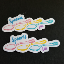 Load image into Gallery viewer, The two stickers on top of a black table