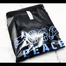Load image into Gallery viewer, The Peace in ASL T-Shirt in a plastic bag
