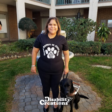 Load image into Gallery viewer, picture of Juanita wearing the shirt. She is next to her service animal in front of a water fountain.