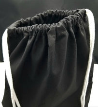 Load image into Gallery viewer, The top of the drawstring bag. The bag is black with white string handles.