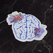 Load image into Gallery viewer, Traumatic Brain Injury Sticker on top of a black marble table.