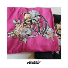Load image into Gallery viewer, Two Wheelchair with Flowers Shirts. A berry shirt on top of a black shirt.