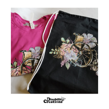 Load image into Gallery viewer, The Wheelchair with Flowers shirt next to the Wheelchair with Flowers Drawstring Bag.