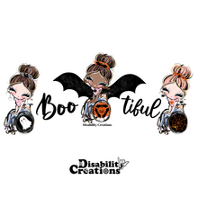 Load image into Gallery viewer, Closer look of the disabled designed of t-shirt that says Boo-tiful! Three ladies loving the Halloween season. The first lady has dangling ghost earrings, and her wheelchair's wheels are black wheels with a ghost in the center. The lady in the middle is dressed as a bat, her bat wings are open, and her wheelchair's wheels have three bats shaping a circle and making a pumpkin in the middle. On her left, it says, "Boo," and on the right, it says, "tiful." The last lady has dangling spider earring
