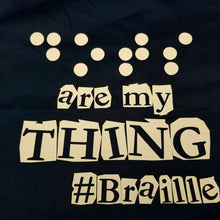 Load image into Gallery viewer, A black tote bag says, &quot;Dots are my thing #Braille&quot; in camel soft foam vinyl. The raised vinyl is used to read &quot;Dots&quot; in Braille. 
