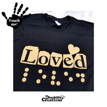 Load image into Gallery viewer, A folded black shirt with the carnel design. On the top left is a black hand. On the palm, it says, &quot;Touch me.&quot; The Disability Creations logo is at the bottom.

