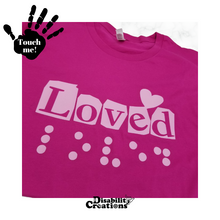 Load image into Gallery viewer, A folded berry shirt with pink design. On the top left is a black hand. On the palm, it says, &quot;Touch me.&quot; The Disability Creations logo is at the bottom.
