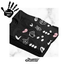 Load image into Gallery viewer, A folded shirt. On the top left is a black hand. On the palm, it says, &quot;Touch me.&quot; The Disability Creations logo is at the bottom.
