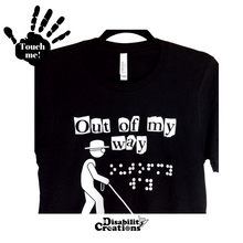 Load image into Gallery viewer, The Out Of My Way (Braille Accessible) T-Shirt on a hanger. A folded shirt. On the top left is a black hand. On the palm, it says, &quot;Touch me.&quot; The Disability Creations logo is at the bottom.
