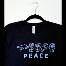 Load image into Gallery viewer, The Peace in ASL T-Shirt in a hanger.
