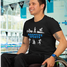 Load image into Gallery viewer, A smiling man is looking away from the camera giving his left-side profile wearing the &quot;Adaptive Sports&quot; t-shirt. The wheelchair user&#39;s hands are on his wheels. A pool is on his right side.
